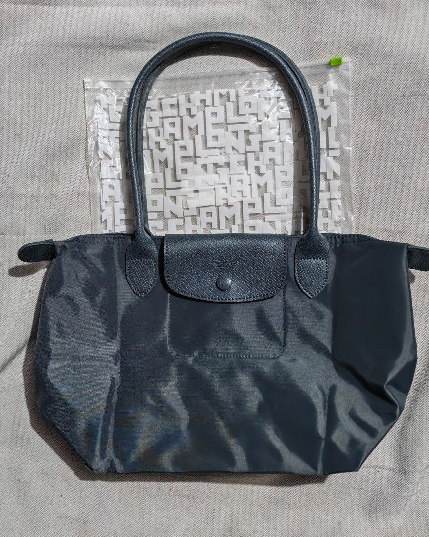Longchamp Le Pliage One Series Gray (Category: Luxury Bags & Wallets) located in Quezon City. Submitted by sureandlegit (Listing ID 1470195616, Image 1). Description: For Sale Longchamp Le Pliage One Series in Gray Medium size Latest LC series Monochromatic color all colors in gray with silver hardware With 2 pockets inside Slightly used, good as brand new Bought from Japan 2nd hand shop as seen on the photo (colors may vary since store lights ar