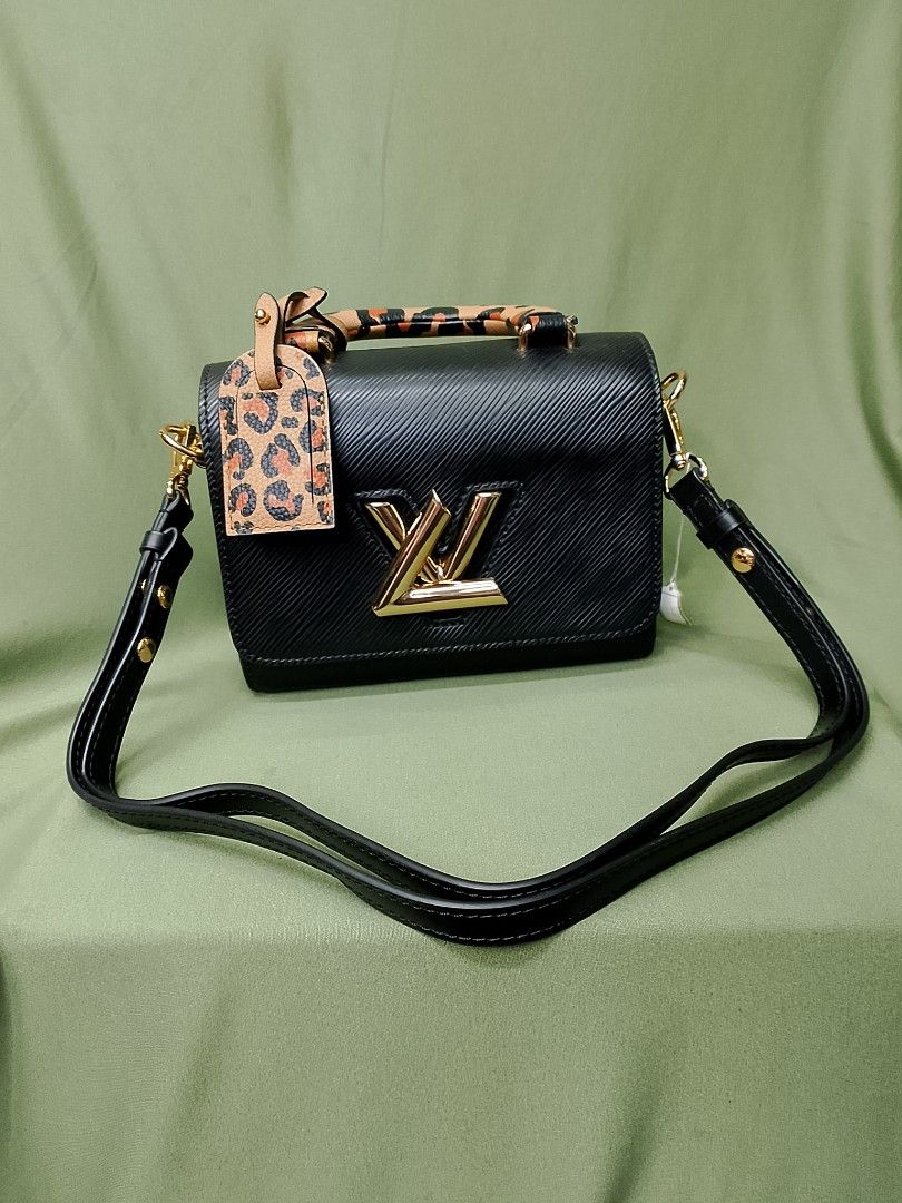 Louis Vuitton Black Epi Leather Bag with Leopard Handle (Category: Luxury Bags & Wallets) located in Baguio. Submitted by luxuryitems08 (Listing ID 1470143497, Image 1). Description: - Material: Black Epi leather with black interior lining and slip pocket - Hardware: Gold-tone LV twist lock closure - Distinctive Details: Includes a stylish leopard print top handle and matching luggage tag - Straps: Comes with a removable black leather shoulder st