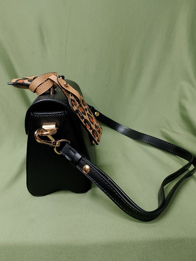 Louis Vuitton Black Epi Leather Bag with Leopard Handle (Category: Luxury Bags & Wallets) located in Baguio. Submitted by luxuryitems08 (Listing ID 1470143497, Image 2). Description: - Material: Black Epi leather with black interior lining and slip pocket - Hardware: Gold-tone LV twist lock closure - Distinctive Details: Includes a stylish leopard print top handle and matching luggage tag - Straps: Comes with a removable black leather shoulder st