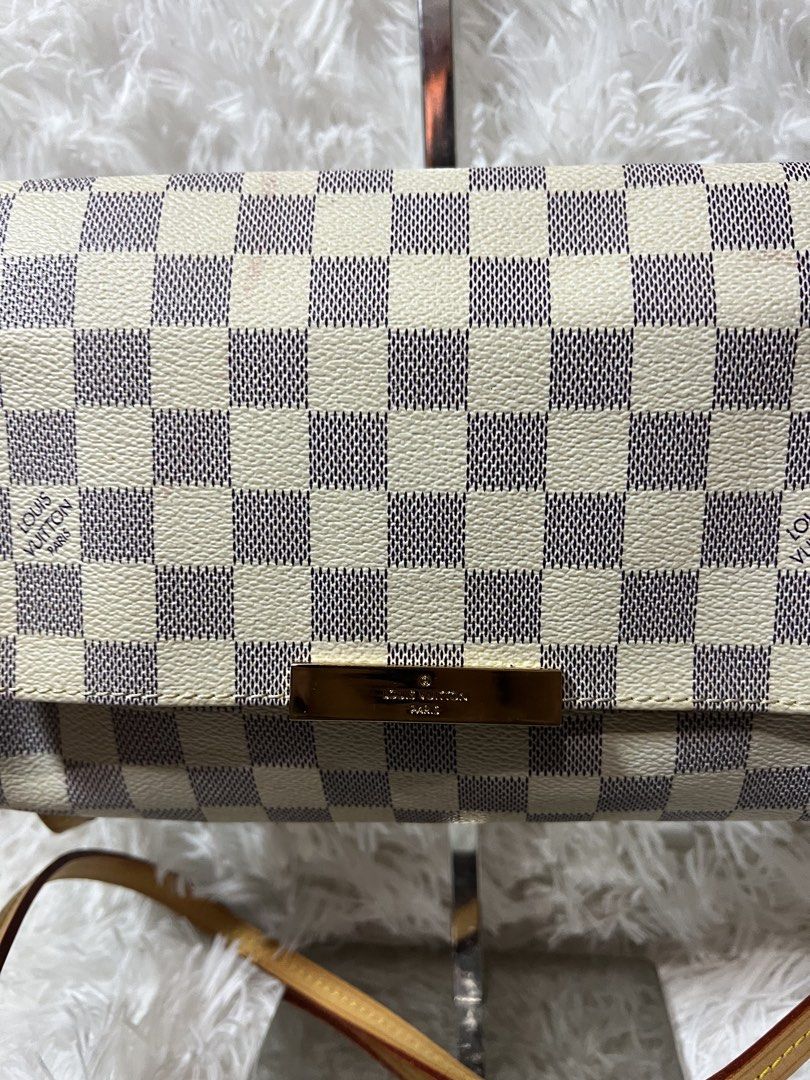 Louis Vuitton Damier Azur Canvas Shoulder Bag (Category: Luxury Bags & Wallets) located in San Carlos. Submitted by jessamaep_deer (Listing ID 1470271677, Image 2). Description: - Authentic Louis Vuitton shoulder bag - Iconic Damier Azur canvas in white and blue-grey - Elegant gold-tone hardware on the front flap and chain strap - Premium tan leather trim with an adjustable strap included - Fabric interior lining equipped with a convenient slip p