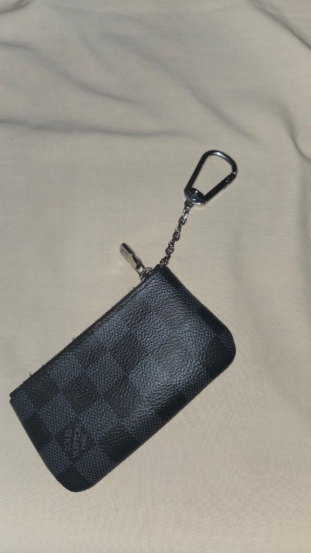 Louis Vuitton Damier Graphite Key Pouch (Category: Luxury Bags & Wallets) located in Cavite. Submitted by tepidelarosa (Listing ID 1470316872, Image 1). Description: - Authentic Louis Vuitton Key Pouch - Damier Graphite canvas in iconic black and grey - Silver-tone hardware with smooth zipper closure - Attached interior key ring on a chain - Louis Vuitton Paris Made in France stamp - Date code: CT0233 - Condition: Excellent / Well-maintained - Me