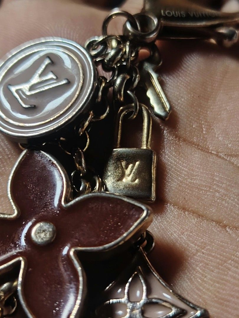 Louis Vuitton Monogram Fleur Charm Keychain (Category: Luxury Accessories) located in Baguio. Submitted by tabuzomaria1422 (Listing ID 1470318639, Image 1). Description: - Authentic gold-tone Louis Vuitton keyring and bag charm - Features dangling LV circle logo, monogram flowers, tiny padlock, and key pendants - Detailed with engraved Louis Vuitton lettering on the clasp - Perfect for dressing up your favorite luxury bag or keeping keys secure -