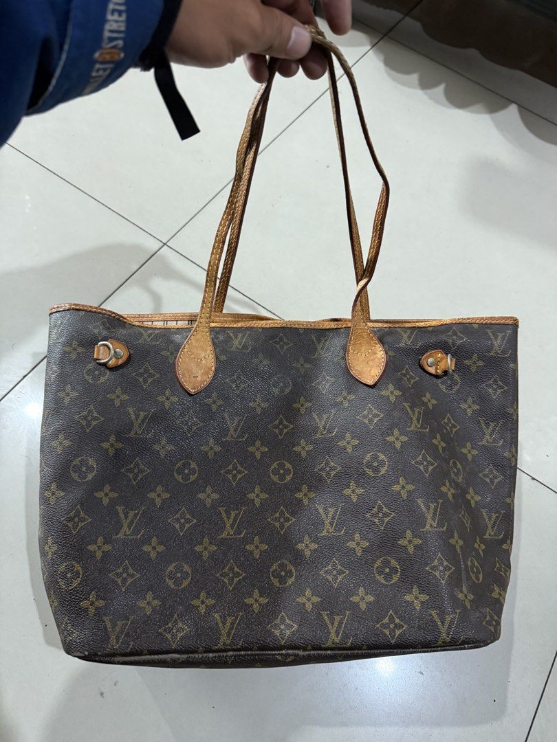 Louis Vuitton Monogram Neverfull Tote Bag (Category: Luxury Bags & Wallets) located in Bacolod City. Submitted by kitcarsonduff (Listing ID 1470182486, Image 1). Description: - Louis Vuitton Neverfull tote bag in classic Monogram canvas - Made in France (Date code: TH0077) - Iconic brown exterior with stylish striped fabric interior lining - Features dual leather shoulder straps, structured base, and an interior zipped pocket - Spacious and sturd