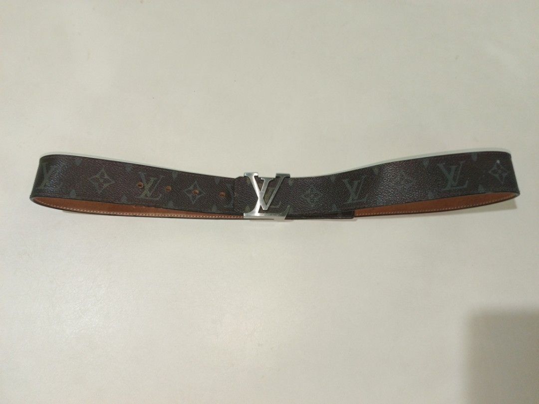 Louis Vuitton Monogram Reversible Belt (Category: Belts) located in Carcar. Submitted by rolandobac92675 (Listing ID 1470269063, Image 3). Description: Brown LV monogram canvas on one side, tan leather on the reverse. Silver-tone LV buckle closure with minor scratches. Multiple punch holes for sizing adjustment. Measures roughly 18 inches down the side based on tape measure photo. Clean edges, solid hardware..