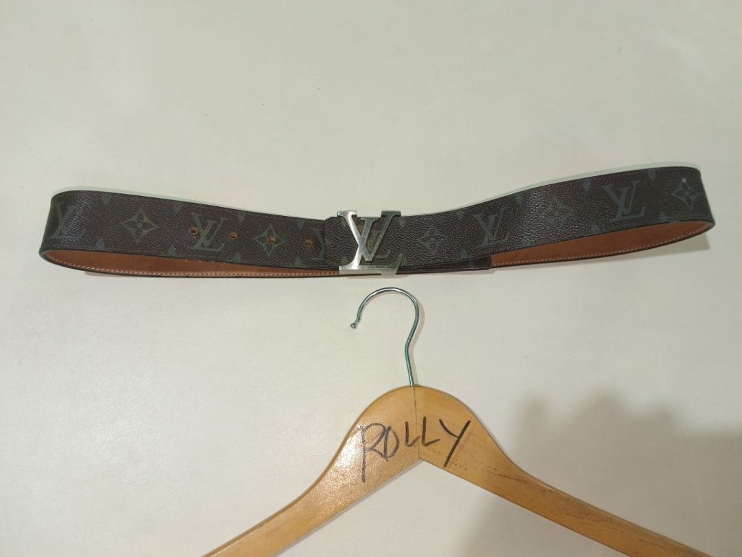Louis Vuitton Monogram Reversible Belt (Category: Belts) located in Carcar. Submitted by rolandobac92675 (Listing ID 1470269063, Image 1). Description: Brown LV monogram canvas on one side, tan leather on the reverse. Silver-tone LV buckle closure with minor scratches. Multiple punch holes for sizing adjustment. Measures roughly 18 inches down the side based on tape measure photo. Clean edges, solid hardware..