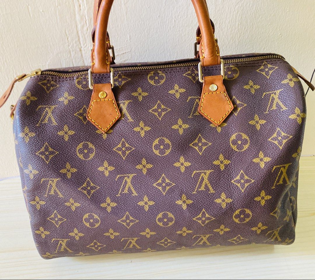 Louis Vuitton Monogram Speedy Handbag (Category: Luxury Bags & Wallets) located in Manila. Submitted by junejanuary (Listing ID 1470192339, Image 2). Description: - authentic monogram canvas pattern - Brown leather handles with gold-tone hardware - Secure zip top closure with leather pull tab - Structured doctor bag silhouette with spacious interior - Condition: Natural patina and typical darkening on leather handles from handling.