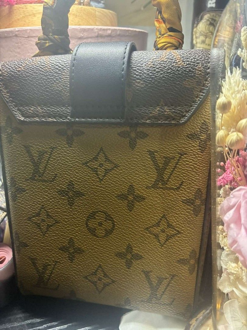 Louis Vuitton Monogram Trunk Bag With Twilly Scarf (Category: Luxury Bags & Wallets) located in Quezon City. Submitted by never_a_clutter (Listing ID 1470294875, Image 2). Description: - Brand: Louis Vuitton - Style: Structured box bag with monogram print - Details: Black leather flap with gold-tone clasp lock - Handle & Strap: Includes matching monogram crossbody strap and a brown/gold twilly-wrapped top handle - Interior: Fabric-lined with a co