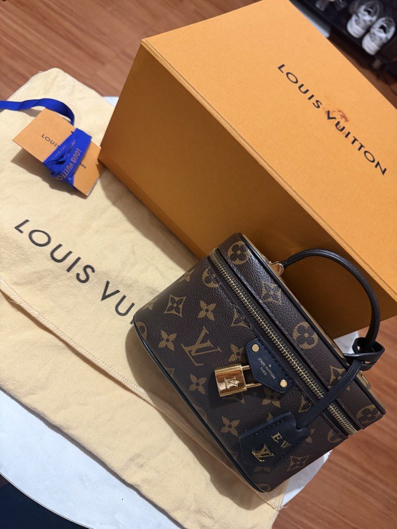 Louis Vuitton Monogram Vanity PM Handbag (Category: Luxury Bags & Wallets) located in Manila. Submitted by arcietan02437 (Listing ID 1470258038, Image 2). Description: - Brand: Louis Vuitton - Style: Monogram Vanity Bag - Color: Dark Brown - Hardware: Gold-tone - Features: Top handle, padlock, and key bell (stamped with initials E.W.) - Straps: Includes detachable leather strap and chain strap - Inclusions: Original box, dust bag, and tag - Condi