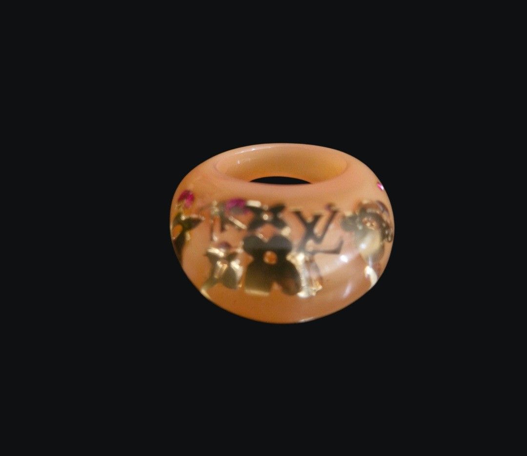 Louis Vuitton Resin Monogram Ring with Box and Pouch (Category: Rings) located in Quezon City. Submitted by mglf1983 (Listing ID 1470174252, Image 2). Description: - Authentic Louis Vuitton resin ring in a gorgeous translucent peach orange shade - Features embedded gold monogram flowers, LV motifs, and delicate pink crystal accents - Trendy and bold chunky band design - Includes original brown cardboard box and velvet drawstring dust pouch - Perf