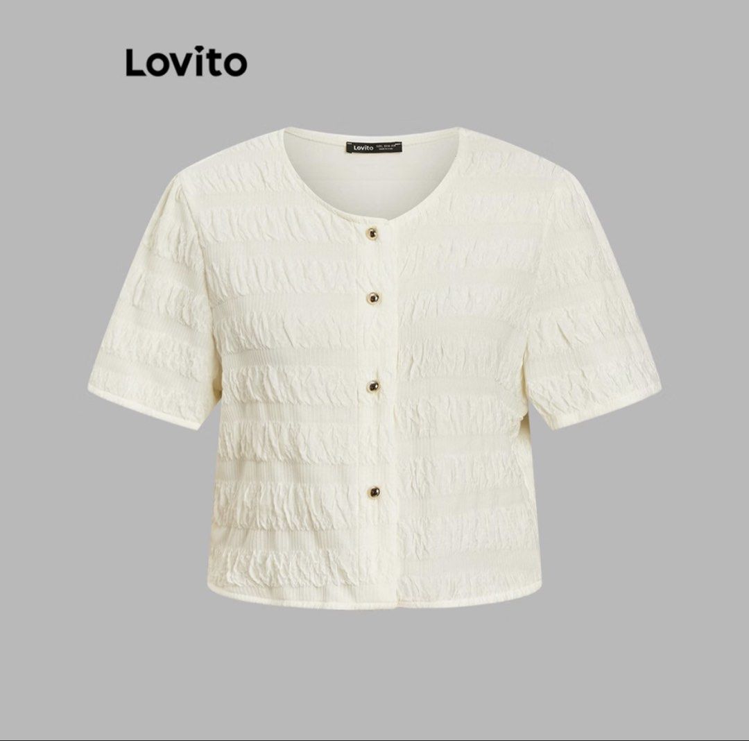 Lovito Button-Up Blouse (Category: Blouses) located in Makati City. Submitted by marymontalve (Listing ID 1470300364, Image 1). Description: - Brand: Lovito - Color: White - Style: Cropped short sleeve blouse - Details: All-over textured crinkle pattern, round neckline, gold-toned front buttons, and chic puff sleeves - Versatility: Great everyday piece, easy to match with high-waisted jeans or skirts orig price: 529.