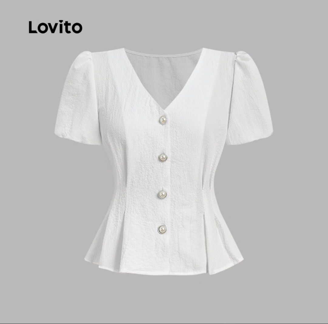 Lovito White Blouse (Category: Blouses) located in Makati City. Submitted by marymontalve (Listing ID 1470300145, Image 1). Description: - Brand: Lovito - Color: Classic White - Style: Peplum blouse with short puff sleeves and V-neckline - Details: Chic row of pearl-style buttons and textured vertical fabric - Fit: Fitted waist that flares out slightly at the hem - Pairing: Great with light wash jeans or skirts for a casual day out - Condition: B