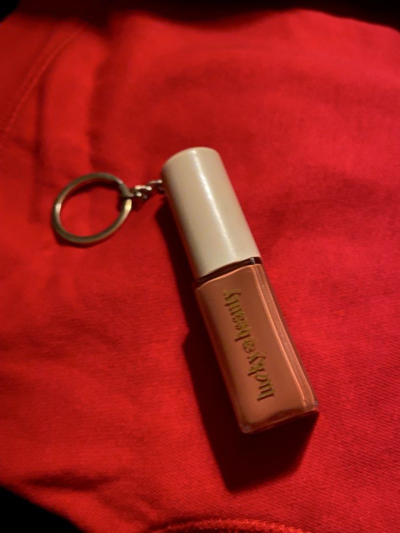 Lucky Beauty Mini Lip Cloud Keychain (Category: Makeup) located in Manila. Submitted by gyroyeezed (Listing ID 1470323306, Image 1). Description: - Authentic Rare Beauty mini lip gloss keychain in a gorgeous nude peach shade - Features a sleek beige cap, clear tube, and stylish gold lettering - Versatile accessory: use as an everyday keyring or a cute bag charm - Excellent, flawless condition with clean metal hardware and a scratch-free body - Re