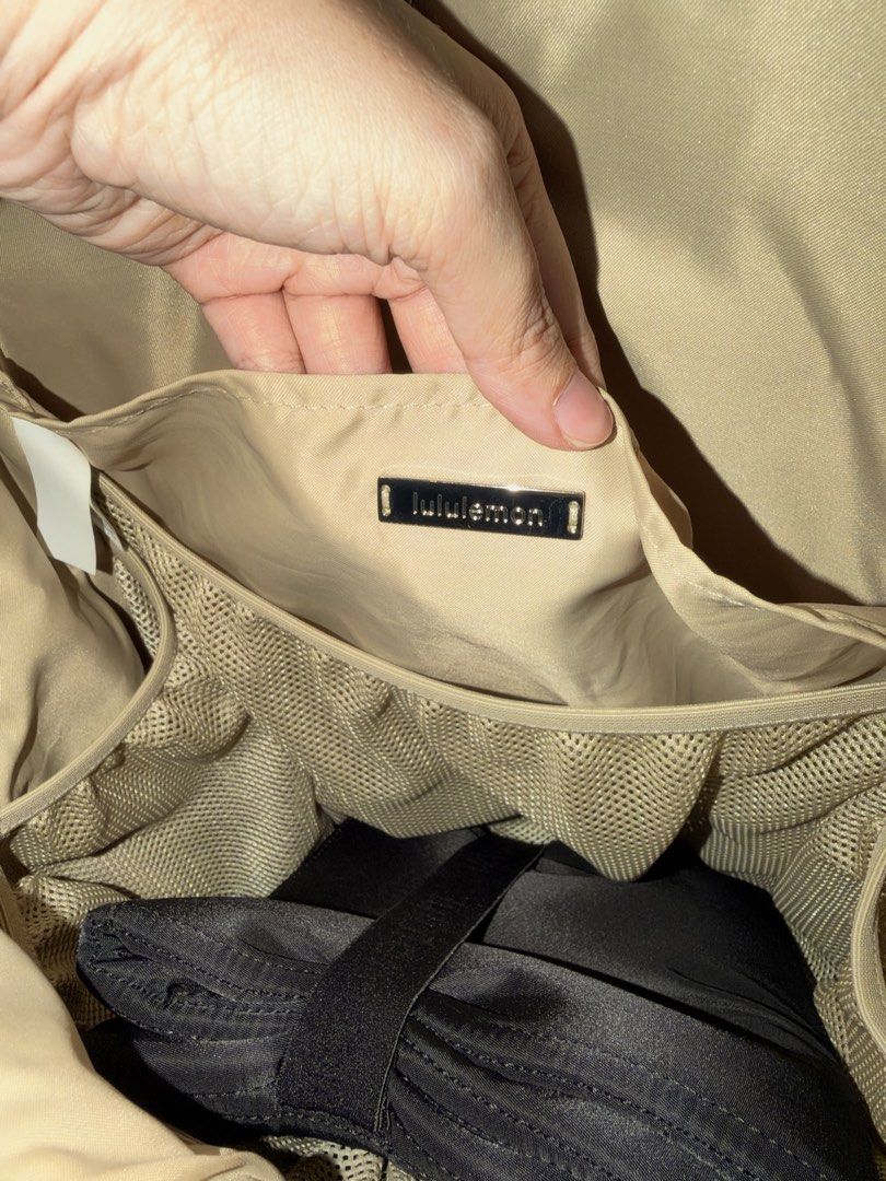Lululemon Black Backpack (Category: Diaper Bags & Wetbags) located in Quezon City. Submitted by ecopalette (Listing ID 1470172195, Image 3). Description: - Brand: Lululemon - Color: Classic black exterior with a stylish beige interior lining - Material: Durable, high-quality nylon - Compartments: Spacious main compartment with double zipper opening - Laptop Storage: Dedicated laptop sleeve secured with an elastic strap - Organization: Multiple me