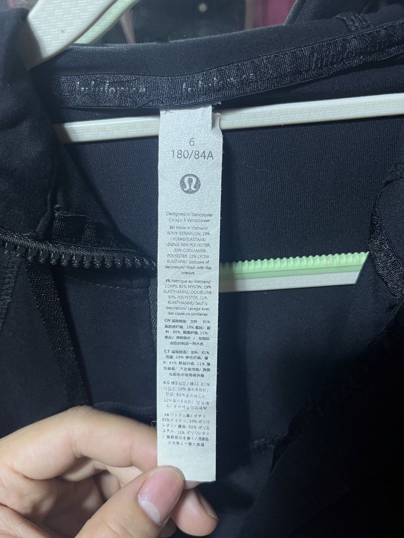 Lululemon Black Zip-Up Hoodie Size 6 (Category: Coats, Jackets and Outerwear) located in Iloilo. Submitted by cloud.thrifts (Listing ID 1470157244, Image 3). Description: - Brand: Lululemon - Color: Classic Black - Size: AU/US 6 - Design: Full-front zip, matching drawstring hood, and signature seam details - Pockets: Secure zippered hand pockets on both sides - Material: Breathable nylon and lycra blend - Details: Iconic logo emblem on back colla