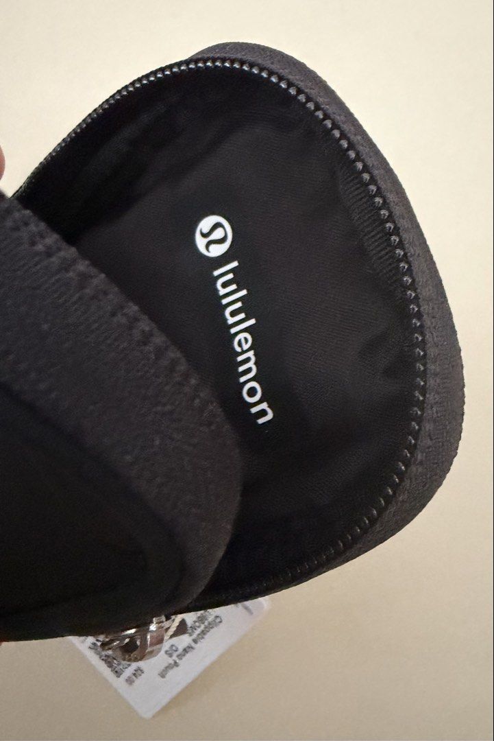 Lululemon Clippable Nano Pouch Black (Category: Purses & Pouches) located in Pasig City. Submitted by jrrhs (Listing ID 1470203349, Image 3). Description: - Brand new with original store tags - Color: Classic Black - Ideal for holding cards, hand sanitizer, or lip balm - Smooth zipper closure with silver-tone logo pull - Features interior Lululemon wordmark print - Convenient clip easily attaches to backpacks or larger bags.