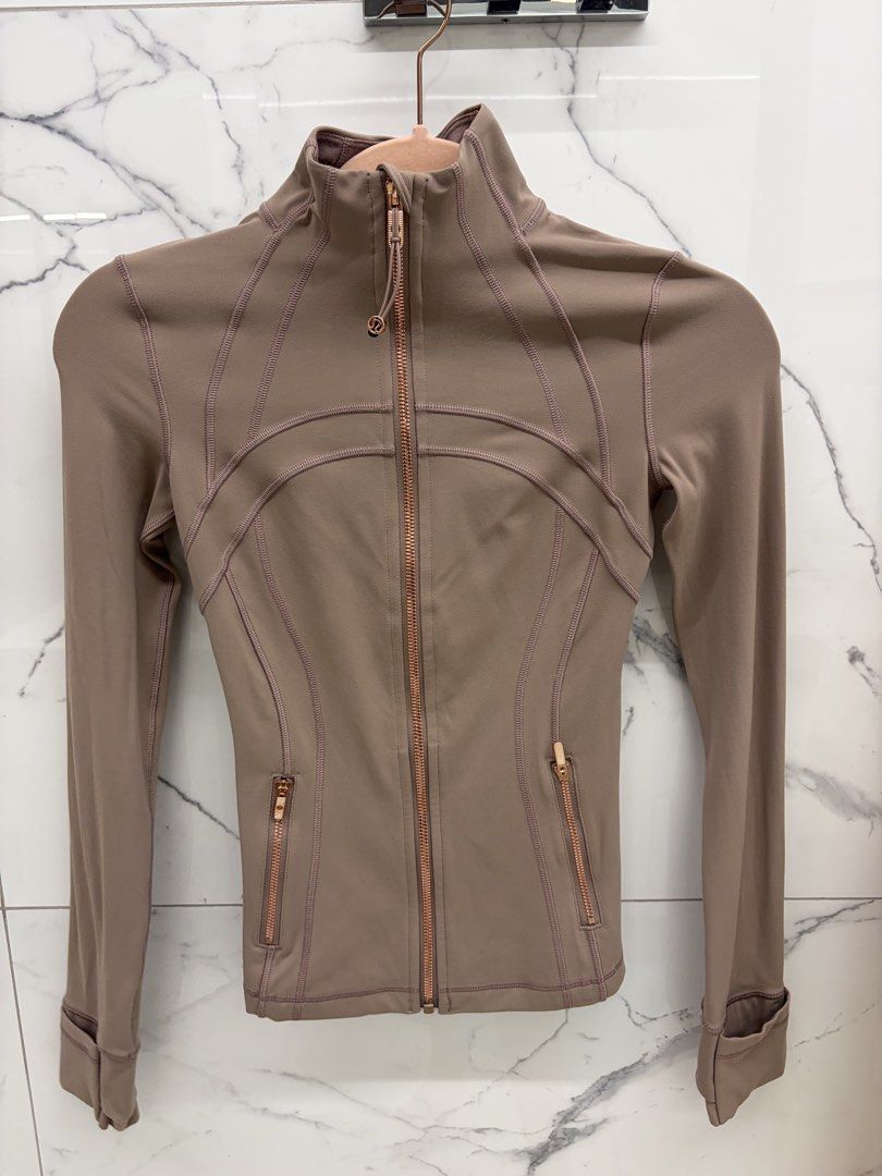 Lululemon Define Jacket Rose Gold Size 0 (Category: Coats, Jackets and Outerwear) located in Manila. Submitted by genyfurrose (Listing ID 1470157696, Image 1). Description: - Brand: Lululemon - Style: Define Jacket - Color: Brownish Taupe with Rose Gold hardware & zippers - Size: 0 (150/72A) - Material: Nylon and Lycra elastane blend (Made in Cambodia) - Features: Thumbholes, zippered front pockets, structured paneled stitching - Condition: Clean