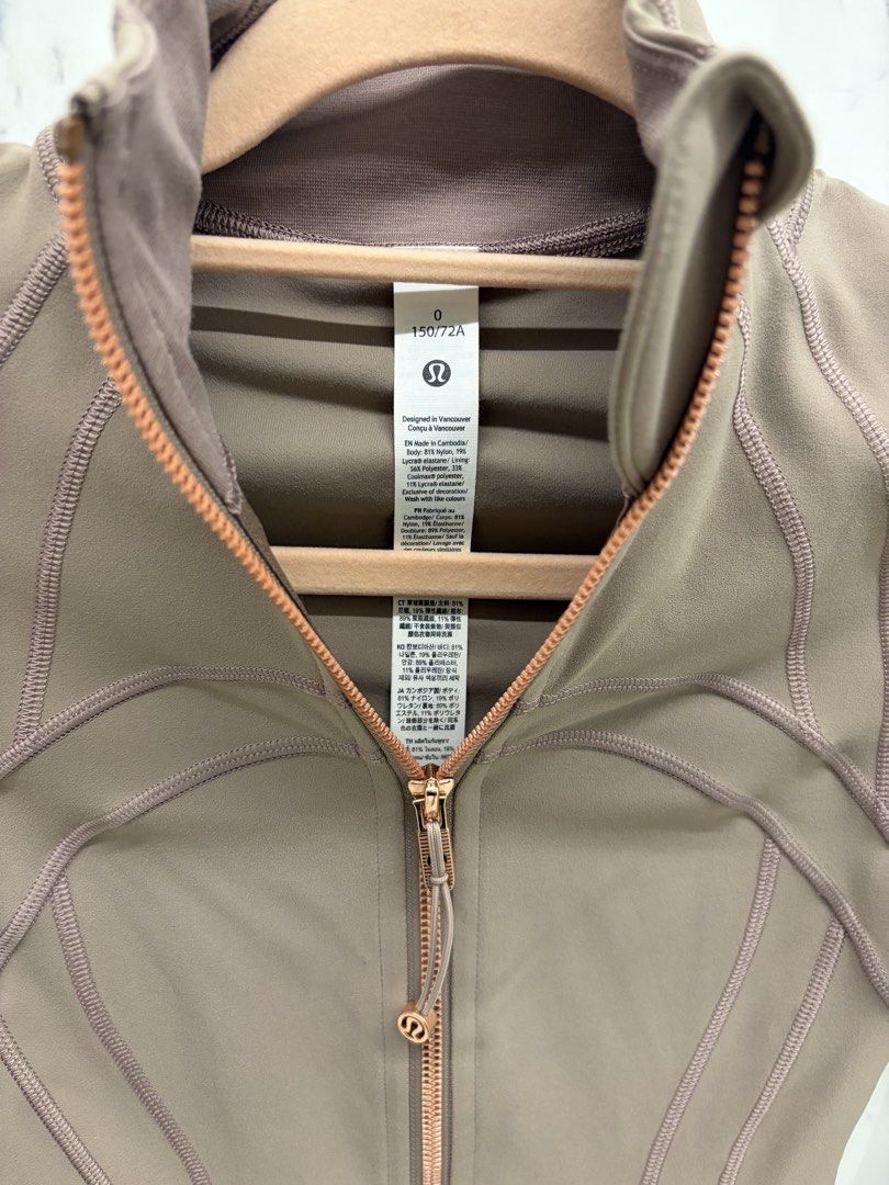 Lululemon Define Jacket Rose Gold Size 0 (Category: Coats, Jackets and Outerwear) located in Manila. Submitted by genyfurrose (Listing ID 1470157696, Image 2). Description: - Brand: Lululemon - Style: Define Jacket - Color: Brownish Taupe with Rose Gold hardware & zippers - Size: 0 (150/72A) - Material: Nylon and Lycra elastane blend (Made in Cambodia) - Features: Thumbholes, zippered front pockets, structured paneled stitching - Condition: Clean