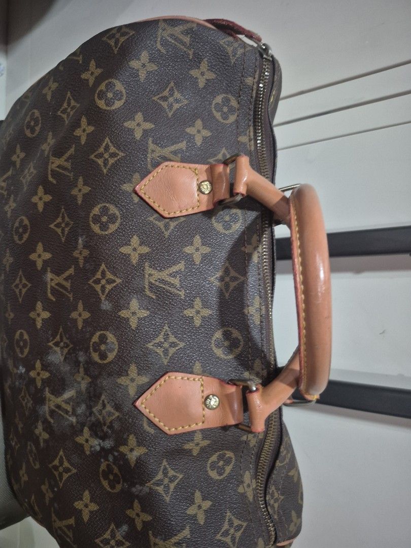 LV Monogram Canvas Duffle Bag (Category: Luxury Bags & Wallets) located in Iloilo. Submitted by gorgeoustatz (Listing ID 1470286096, Image 2). Description: - LV Monogram travel bag - Classic brown canvas with signature LV print - Features leather handles, piping, and dual top-zipper closure - Convenient built-in pull handle with wheels on one side - Condition: Shows mold spots and surface wear on canvas and leather trim due to storage - Perfect l