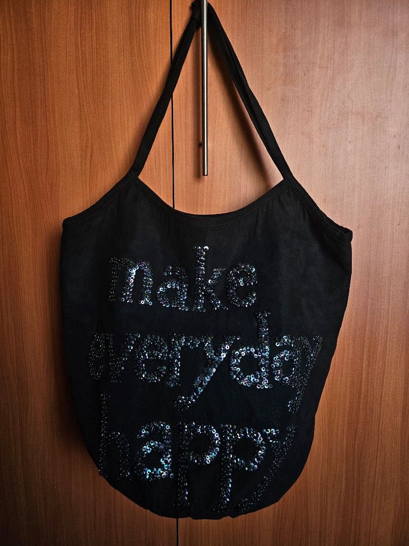 Make Everyday Happy Black Sequinned Tote Bag (Category: Tote Bags) located in Mandaluyong City. Submitted by ohwmaria (Listing ID 1470231041, Image 1). Description: - Brand/Designer: BY AISSATA MALHAIRE (pink interior tag with website) - Design: Black fabric tote with iridescent sequin lettering 'make everyday happy' - Features: Roomy interior with secure zip closure and double shoulder straps with strap detail - Style: Fun, casual everyday bag t