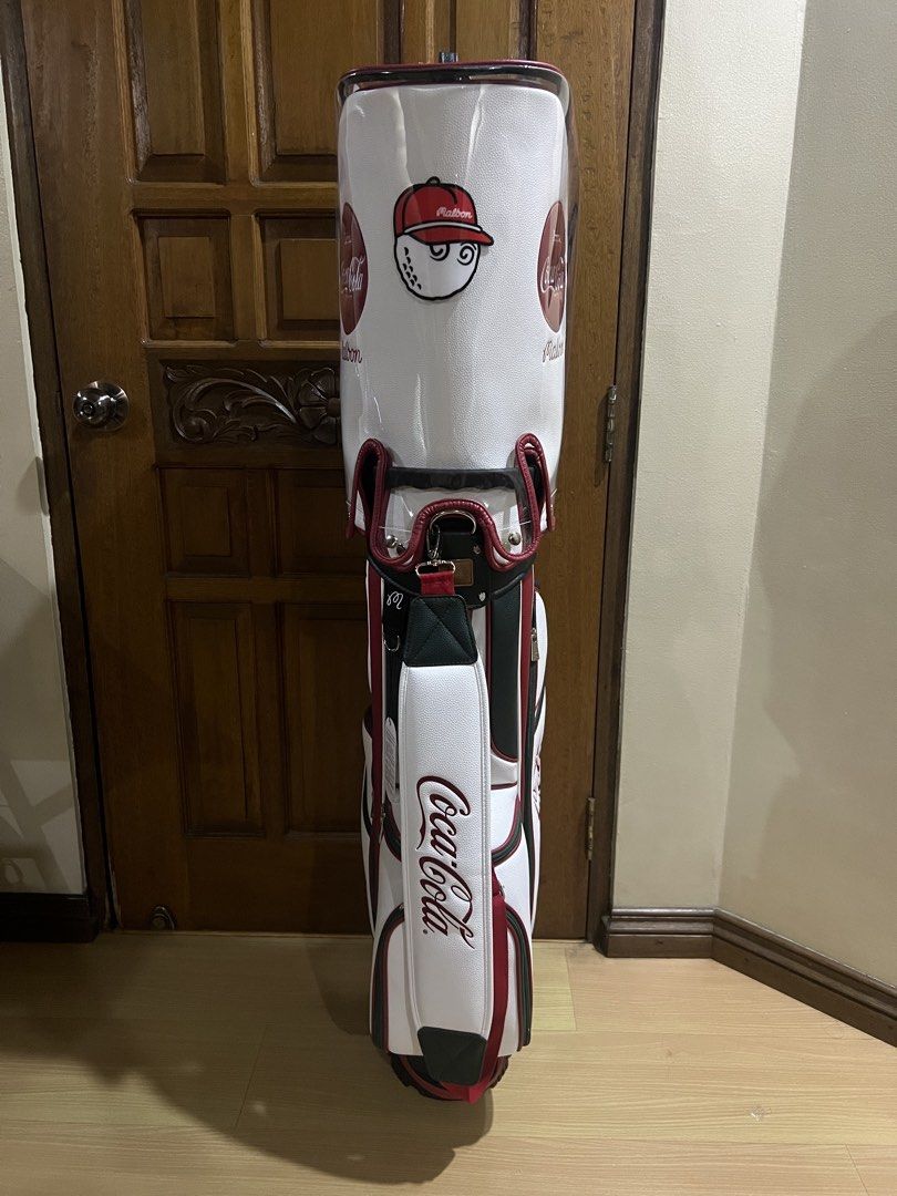Malbon x Coca-Cola Golf Bag White Red (Category: Golf) located in Manila. Submitted by kensoncai8 (Listing ID 1470300558, Image 3). Description: - Limited Malbon Golf x Coca-Cola collaboration - Premium white synthetic leather with classic red branding and pinstripe details - Multiple zippered compartments for organized storage - Includes matching hood cover and comfortable padded shoulder strap - Excellent clean condition with protective plastic