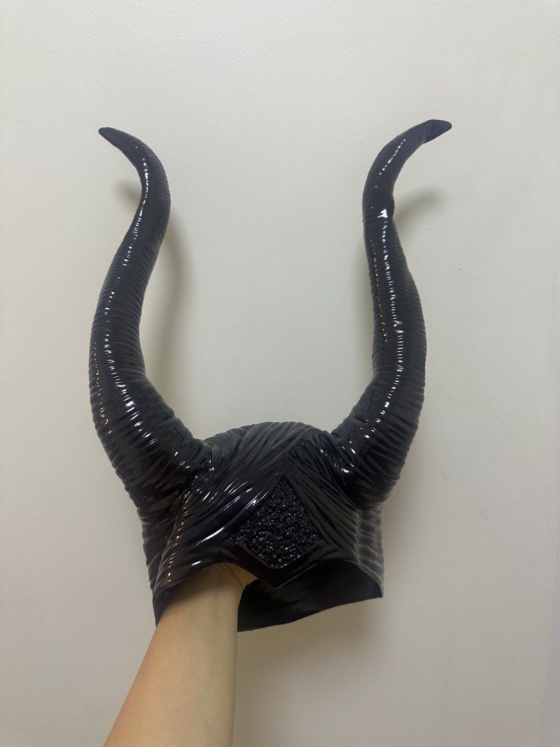 Maleficent Horns Headpiece Costume Accessory (Category: Hair Accessories) located in Makati City. Submitted by lbn.jn (Listing ID 1470319551, Image 1). Description: - Design: Maleficent-inspired black horned headpiece - Finish: Glossy with textured ridges on the long curved horns and center forehead, very high quality - Fit: Cap-style design that fits comfortably over the head - Condition: Worn once for a shoot, very clean, and carefully stored -
