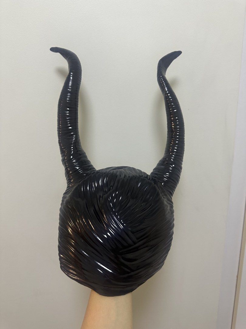 Maleficent Horns Headpiece Costume Accessory (Category: Hair Accessories) located in Makati City. Submitted by lbn.jn (Listing ID 1470319551, Image 2). Description: - Design: Maleficent-inspired black horned headpiece - Finish: Glossy with textured ridges on the long curved horns and center forehead, very high quality - Fit: Cap-style design that fits comfortably over the head - Condition: Worn once for a shoot, very clean, and carefully stored -