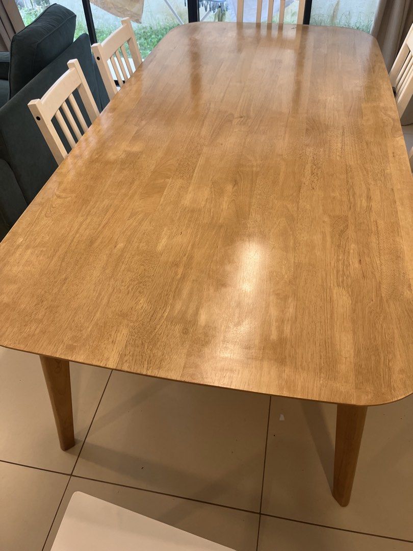 Mandaue Foam Elland 8 Seater Dining Table (Category: Tables & Sets) located in Quezon City. Submitted by knepler_rylan (Listing ID 1470267956, Image 3). Description: AVAILABLE DECEMBER 1 2026 Purchased from Mandaue Foam in June 2024 for ₱19,000. Material: Solid Rubberwood Color: Teak Dimensions: 200x100x74cm Has some flaws in clear coat. Hard to capture on photos. Also selling the 6 white ikea dining chairs for 4k. Will sell all together for 6k. 