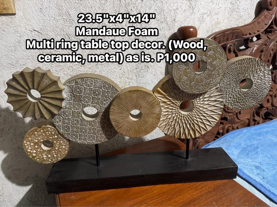 Mandaue Foam Multi Ring Table Top Decor. As is (Category: Wall Decor) located in Cainta. Submitted by elainelawenko (Listing ID 1470264204, Image 1). Description: - Brand: Mandaue Foam - Item: Circle polyresin table top decor with sturdy black base - Dimensions: 23.5" x 4" x 14" - Condition: Has a crack at the joint between two rings, needs adhesive to fix (Selling as-is) - Original Price: ₱2,655 - Selling Price: ₱1,000 only.