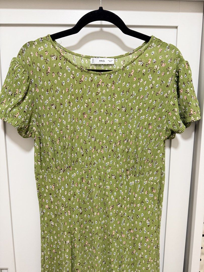 Mango Green Floral Midi Dress (Category: Dresses) located in Manila. Submitted by .yansells (Listing ID 1470336479, Image 2). Description: - Brand/Style: Mango green midi dress with a dainty white and pink floral print - Details: Round neckline, short sleeves with slight gathering, and a chic high side slit - Fabric: Lightweight, textured crinkle finish that doesn't cling - Condition: Worn once for a wedding, freshly washed, and carefully stored.