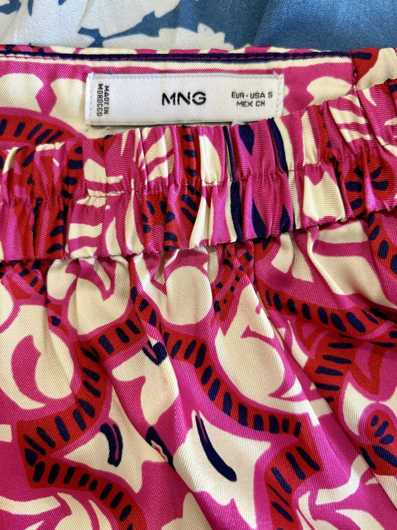 Mango Mango Pink Patterned Shorts Size S (Category: Shorts) located in Manila. Submitted by isabelle_1104 (Listing ID 1470277522, Image 3). Description: - Brand: MNG - Pattern & Colors: Bright pink, red, and cream - Size: EUR-USA S / MEX CH - Design: Elastic waistband at the back with a smooth front panel and pleated details - Material: Lightweight fabric - Origin: Made in Morocco - Condition: Great vibrant piece for warm weather.