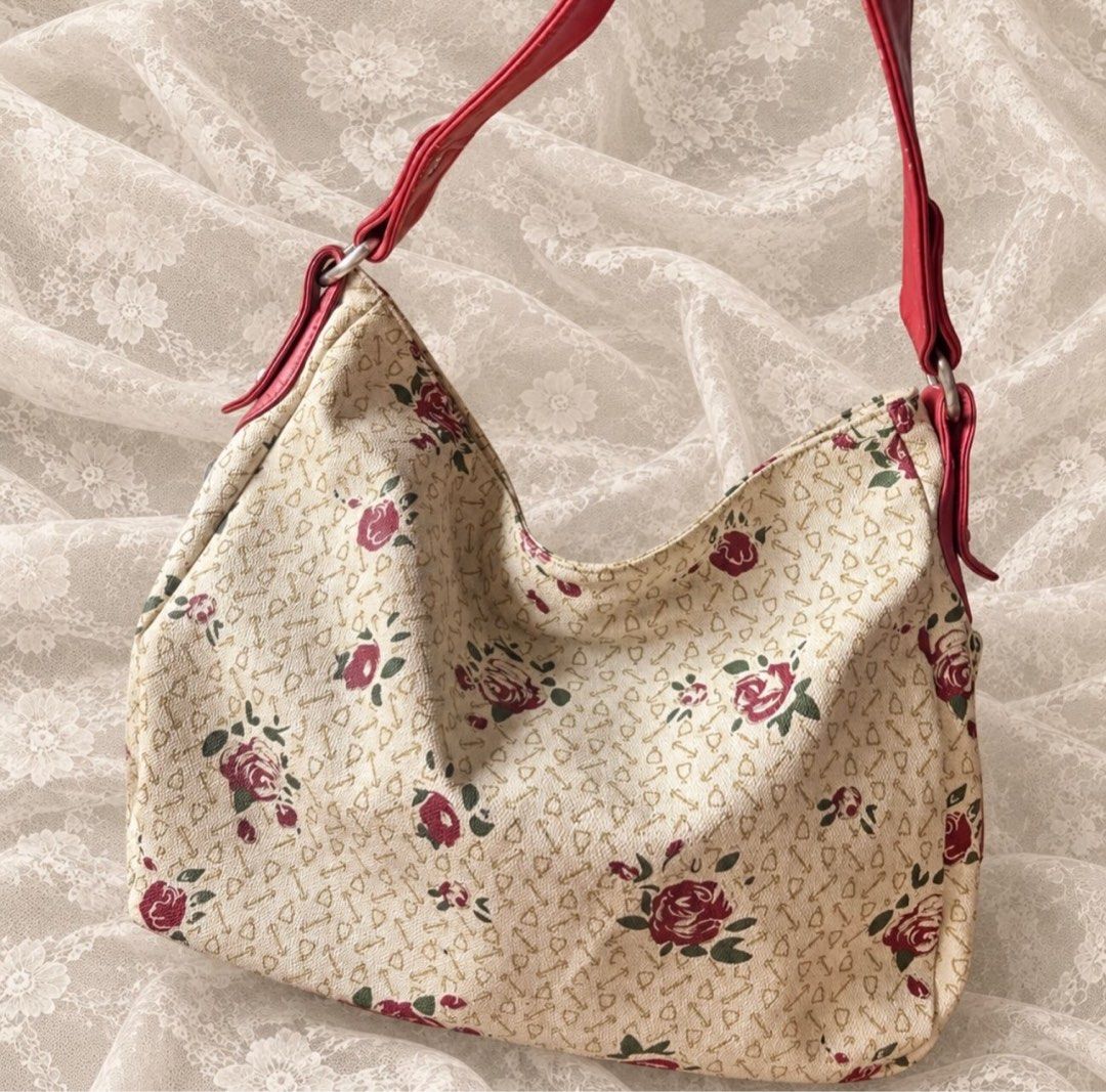 Manmont floral shoulder bag with red straps (Category: Shoulder Bags) located in Manila. Submitted by calliope777 (Listing ID 1470213521, Image 1). Description: - Elegant cream handbag with a red rose print and cute key/heart motifs - Vibrant red faux leather shoulder straps with stylish metal rings - Striped fabric interior featuring authentic Manmont branding - Multiple interior compartments and zipped pockets to keep your items organized - Con