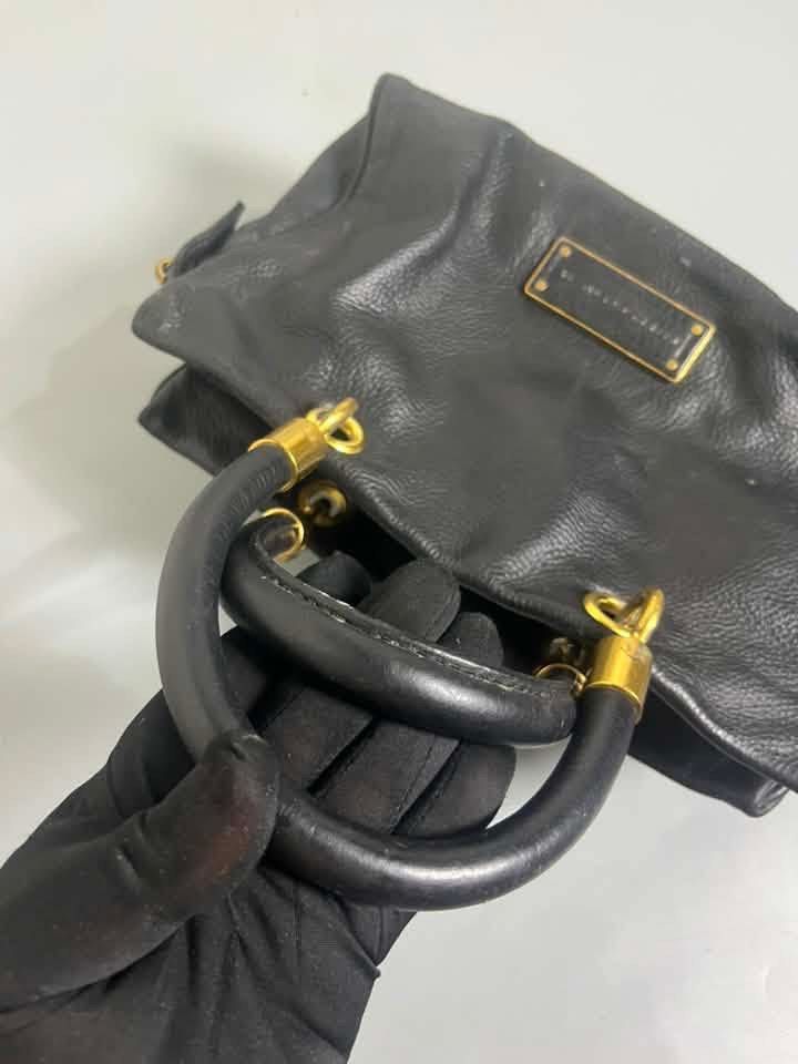 Marc by Marc Jacobs Classic Q (Category: Luxury Bags & Wallets) located in Manila. Submitted by royalpengwen (Listing ID 1470307814, Image 1). Description: - Brand: Marc by Marc Jacobs - Material: Genuine black leather with gold-tone hardware - Closure: Secure zip-top closure - Handles: Structured top handles with metallic details - Interior: Fabric lining with logo pattern, one zip pocket, and slip pockets - Origin: Made in Indonesia - Condition