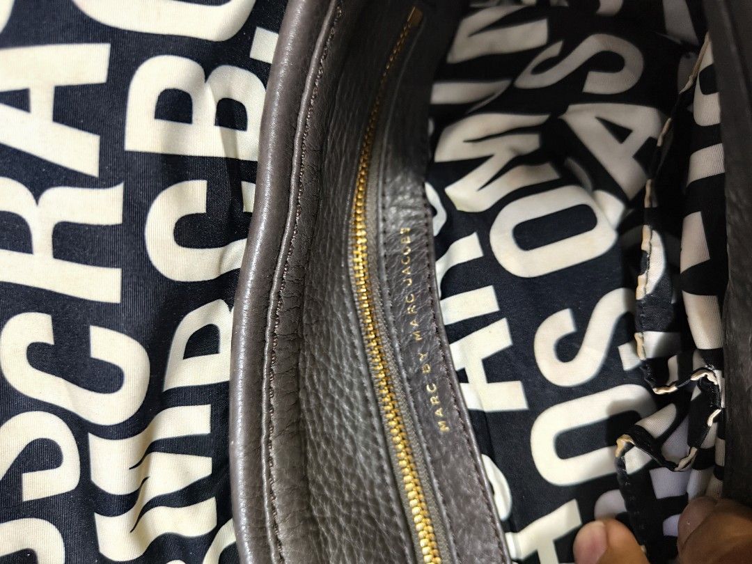 Marc by Marc Jacobs Grey Leather Shoulder Bag (Category: Luxury Bags & Wallets) located in Davao. Submitted by navil01 (Listing ID 1470284107, Image 2). Description: - Brand: Marc by Marc Jacobs - Style: Shoulder Bag - Material: Premium dark grey pebbled leather - Hardware: Gold-tone logo plaque plate - Interior: Black and white printed fabric lining with a secure zipper pocket - Closure: Front flap - Condition: Excellent, ready to use - Message 