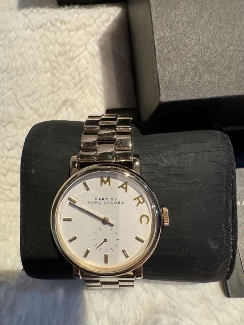 Marc by Marc Jacobs Watch (Category: Women's Watches) located in Valenzuela. Submitted by wisetree_18aeb6 (Listing ID 1470190123, Image 3). Description: - Brand: Marc by Marc Jacobs - Design: Gold tone metal bracelet with a clean white dial and unique gold-tone 'MARC' lettering on the bezel - Features: Functional sub-dial at the bottom - Inclusion: Comes with original black presentation box - Condition: Well-maintained and 100% authentic - Shippi