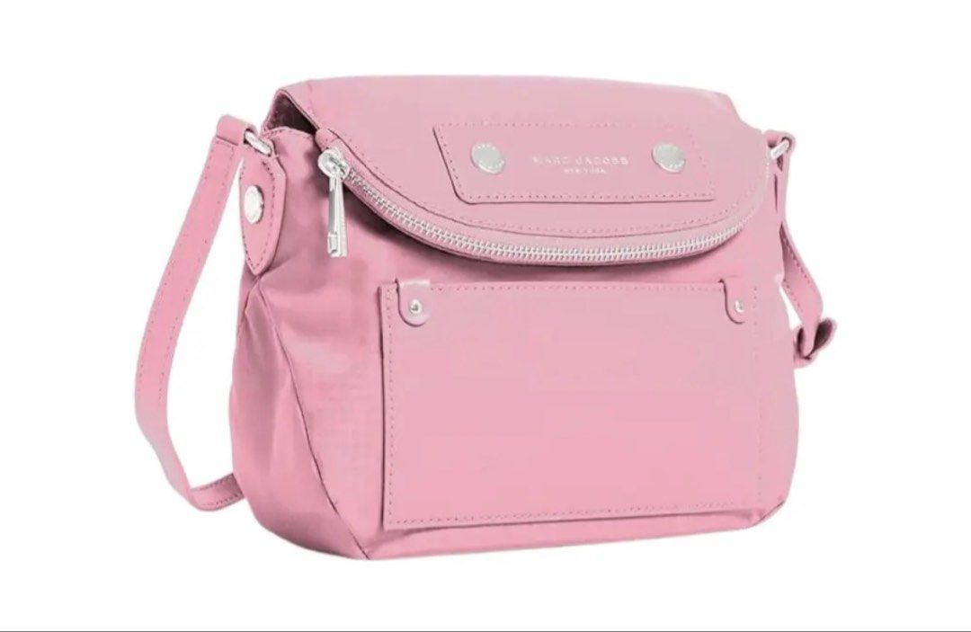 Marc Jacobs pink nylon crossbody bag (Category: Luxury Bags & Wallets) located in Taguig. Submitted by jrlaz27 (Listing ID 1470270864, Image 1). Description: - Brand: Marc Jacobs - Style: Crossbody bag - Color/Material: Light pink nylon with silver-tone hardware - Features: Front flap pocket, top zip closure, adjustable shoulder strap - Condition: Brand new with tags attached, protective wrapping on strap, pristine interior and exterior.
