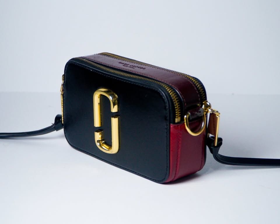 Marc Jacobs Snapshot Black Red Burgundy (Category: Cross-body Bags) located in Caloocan City. Submitted by jnlchvz0612 (Listing ID 1468994554, Image 3). Description: - Authentic Marc Jacobs Snapshot bag - Colorway: Black, red, and burgundy - Hardware: Iconic gold-tone double J logo - Compartments: Double zip design with leather pull tabs - Style: Compact crossbody for everyday use - Inclusions: Bag only.