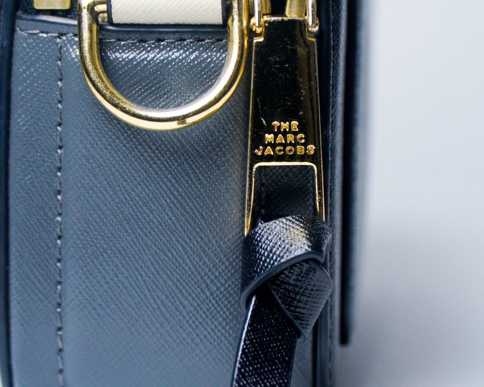 Marc Jacobs Snapshot Black White (Category: Cross-body Bags) located in Taguig. Submitted by jnlchvz0612 (Listing ID 1470188867, Image 3). Description: - Authentic Marc Jacobs camera bag in classic black and white leather - Eye-catching gold-tone Double J logo hardware on the front - Secure top zip closure for your daily essentials - Includes a matching black adjustable strap with gold metal clasps - Compact size, perfect for casual days or night