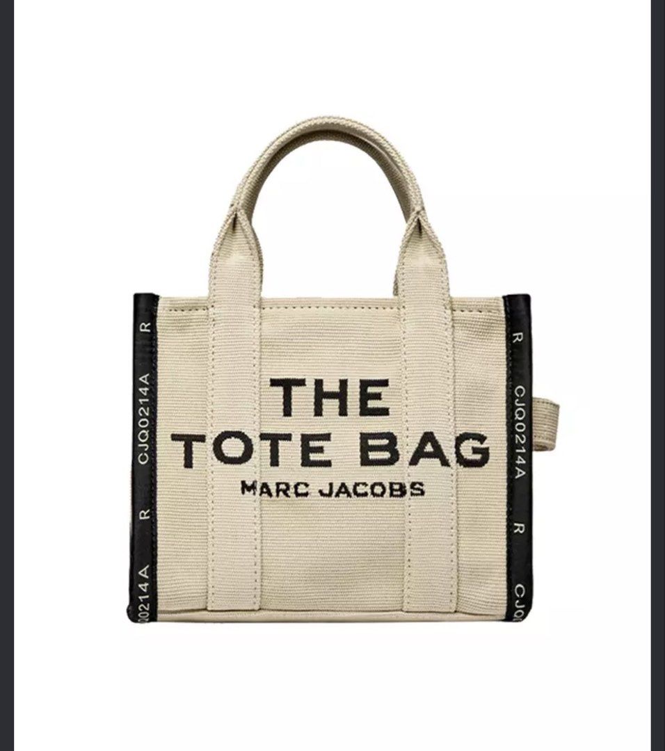 Marc Jacobs The Tote Bag Canvas (Category: Tote Bags) located in Cainta. Submitted by nastyak (Listing ID 1470206691, Image 1). Description: MESSAGE ME FOR ACTUAL PHOTOS Brand: Marc Jacobs - Style: The Tote Bag Large - Color: Beige with black text graphic - Material: Durable canvas - Features: Dual top carry handles, sturdy vertical webbing straps, and printed black side panels - Perfect for daily use, can fit 15-17 inch laptops.