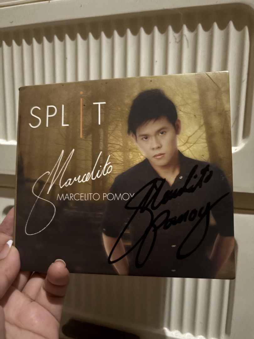 Marcelito Pomoy Split Signed Autographed CD Album (Category: CDs & DVDs) located in Iloilo. Submitted by modern.apothecary (Listing ID 1470271390, Image 1). Description: - Artist & Album: Marcelito Pomoy - Split - Autograph: Signed directly on the cover in black marker - Packaging: Standard CD case in gold tones featuring a portrait of the artist - Condition: Well-stored with minimal wear on edges - Rarity: Rare find for fans and collectors.