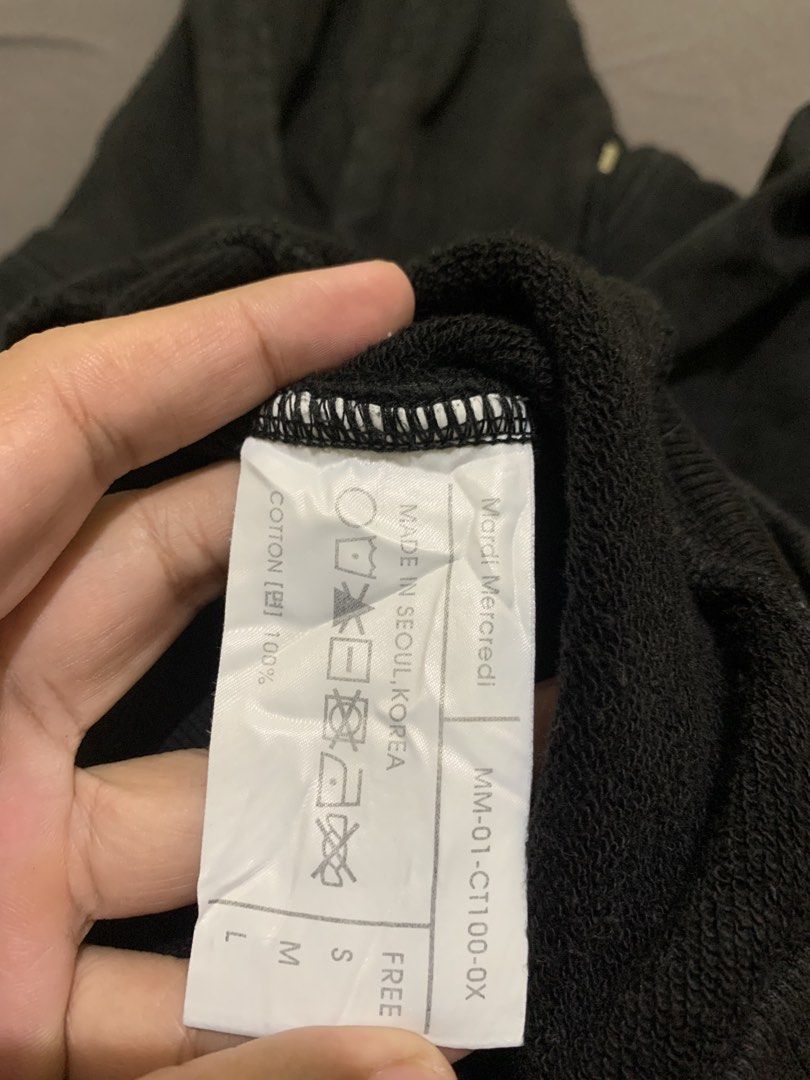 Mardi Mercredi (Category: Tshirts & Polo Shirts ) located in Roxas City. Submitted by vaultcultureco. (Listing ID 1470288907, Image 3). Description: - Brand: Mardi Mercredi - Color: Black - Size: Medium (MM-01-CT100-0X) - Material: 100% Cotton, Made in Seoul, Korea - Condition: 7/10 (pre-loved with gentle signs of use) - Features: Comfortable hood, front pocket, iconic logo graphic.