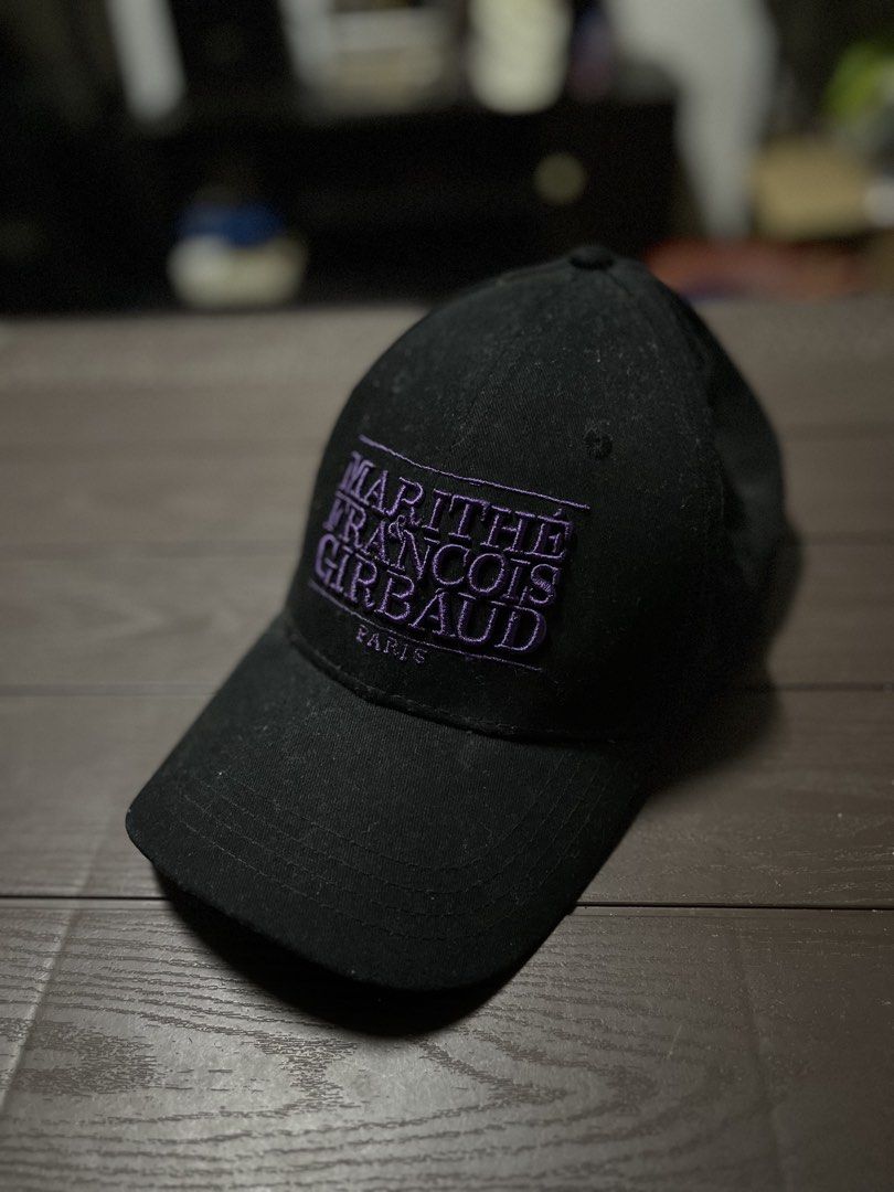 Marithe Francois Girbaud Black Cap With Purple Embroidery (Category: Caps & Hats) located in Meycauayan. Submitted by ranastridran (Listing ID 1470343371, Image 3). Description: - Brand: Marithé François Girbaud Paris - Color: Classic black with a distinct purple embroidered logo patch - Closure: Adjustable strapback with a metallic buckle - Details: Features inside branding tape and standard care label - Condition: Clean structure with minimal w