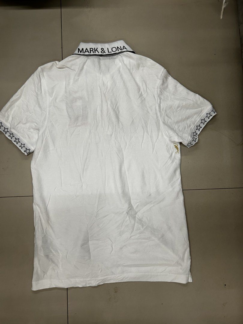 Mark & Lona White Skull Polo Shirt (Category: Tshirts & Polo Shirts ) located in Cebu City. Submitted by jkeive (Listing ID 1470197149, Image 3). Description: - Brand: Mark & Lona - Color: White - Size: Available upon request - Design: Short sleeves with black star pattern on cuffs, embroidered skull graphic and logo lettering on chest - Details: Classic collar with brand text on the back, gold buttons on placket, and embroidered golfer silhouett