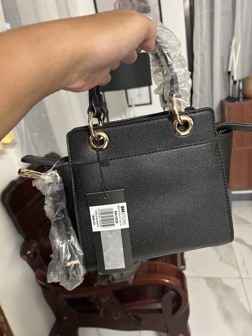 Matthews Black Luke Handbag Bag (Category: Luxury Bags & Wallets) located in Cavite. Submitted by florabells (Listing ID 1470273193, Image 2). Description: - Brand: Matthews (Model: Luke) - Color: Black with chic gold hardware - Material: Textured leather-look - Condition: Brand new, never used, straight from the store with original SM Store tag (₱1,999.00) - Features: Main zipper compartment with inner divider - Inclusions: Top handles (still wr
