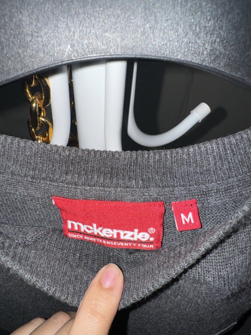 McKenzie Grey Knit Sweater Size M (Category: Longsleeves) located in La Trinidad. Submitted by prelovedandfindsbyji (Listing ID 1470285301, Image 3). Description: - Brand/Model: McKenzie Grey Knit Sweater - Size: Men's Medium - Design: Crew neck with ribbed collar, cuffs, and hem - Special Features: Stylish elbow patches, ribbed shoulder panels, and embroidered chest logo - Condition: Excellent everyday piece, perfect for cooler weather.