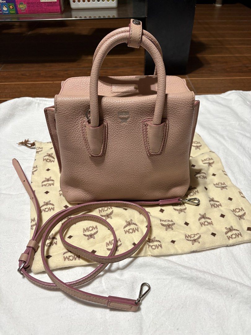 MCM Pink Leather (Mini Milla Bag) (Category: Luxury Bags & Wallets) located in Bulacan. Submitted by love2loved (Listing ID 1470279608, Image 1). Description: - Am pink pebbled leather bag from MCM - Dual top handles and a detachable shoulder strap for versatile carrying - Sleek silver-tone hardware with a subtle MCM logo stamped on the front Good condition Signs of wear/used Size : small Rubber lining intact Wala bak bak or butas Flaws: wala yun