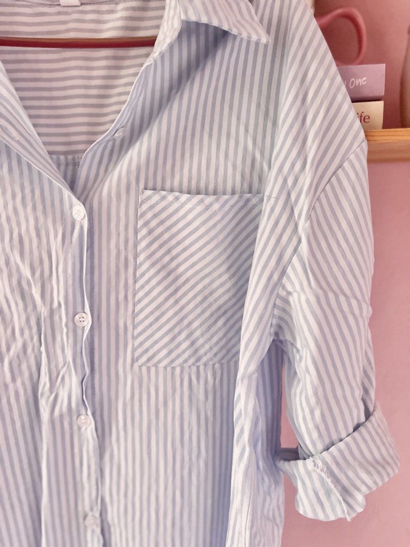 MEIPAIYIDING Blue White Striped Button Down Shirt (Category: Shirts) located in Imus. Submitted by muyingyingyinggg (Listing ID 1470236043, Image 3). Description: - Light blue and white vertical striped oversized shirt - Classic collar with front button closure - Single chest pocket and roll-up sleeves with button tabs - Lightweight, breathable fabric ideal for layering or solo wear - Condition: Excellent, no flaws found.