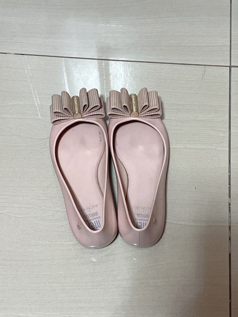 Mel Dreamed by Melissa + Jason Wu Bow Flats (Category: Flats & Sandals) located in Makati City. Submitted by aiscraze (Listing ID 1470254256, Image 2). Description: - Brand: Melissa - Style: Jelly flats / Slip-on - Color: Soft pink with gold-tone hardware - Design: Pleated ribbon bow upfront - Size: Kids EU 33 / US 2 / JPN 20.5 - Origin: Made in Brazil - Condition: Noticeable wear on inner footbed soles, structurally solid otherwise.