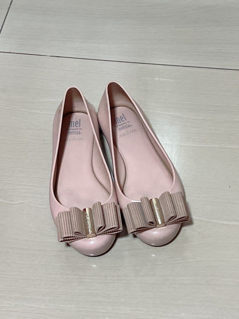 Mel Dreamed by Melissa + Jason Wu Bow Flats (Category: Flats & Sandals) located in Makati City. Submitted by aiscraze (Listing ID 1470254256, Image 1). Description: - Brand: Melissa - Style: Jelly flats / Slip-on - Color: Soft pink with gold-tone hardware - Design: Pleated ribbon bow upfront - Size: Kids EU 33 / US 2 / JPN 20.5 - Origin: Made in Brazil - Condition: Noticeable wear on inner footbed soles, structurally solid otherwise.