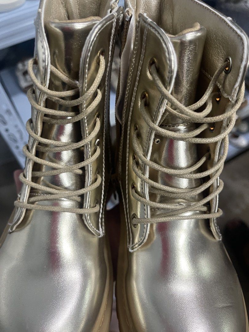 Metallic Gold Combat Boots with Chunky Sole (Category: Boots) located in Manila. Submitted by youngwater-5113 (Listing ID 1470179807, Image 1). Description: - Style: Metallic gold lace-up combat boots with tags still attached - Sole: Chunky pinkish rubber platform with heavy tread - Convenience: Functional easy wear - Details: Round toe, tonal laces, and metal eyelets - Condition: Brand new with tags .