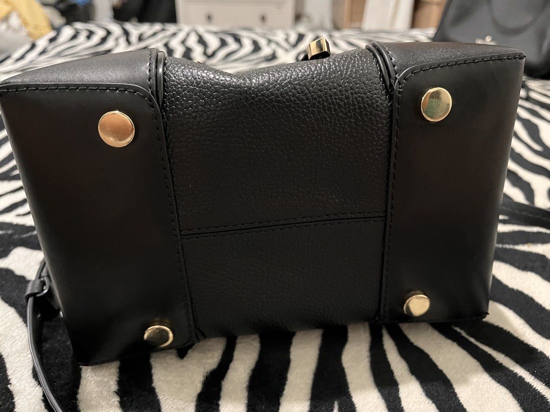 Michael Kors Black Leather Bucket Bag (Category: Luxury Bags & Wallets) located in Quezon City. Submitted by pickleballpaddle (Listing ID 1470327976, Image 2). Description: - Brand: Michael Kors - Material: Premium black pebbled leather - Hardware: Gold-tone with protective bottom feet - Closure: Secure drawstring top - Strap: Removable and adjustable shoulder strap - Interior: Clean lining with a convenient zippered pocket - Structure: Sturdy ba